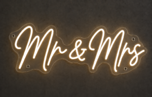 Mr and Mrs neon sign in warm white LED neon script on contour-cut clear acrylic with standoff fixings, mounted on a dark wall